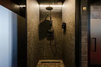 a bathroom with a shower with a shadow of a person at Supper Boutique Suites in Amsterdam