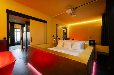 a bedroom with a bed and a mirror at Supper Boutique Suites in Amsterdam