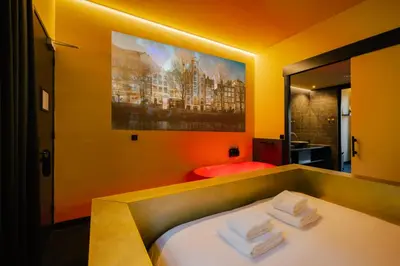 a bedroom with a bed with towels on it at Supper Boutique Suites in Amsterdam