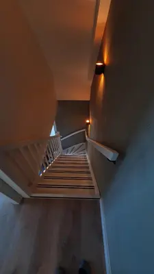 a staircase in a house with lights on the ceiling at Hotelboerderij Akkerlust in Leidschendam