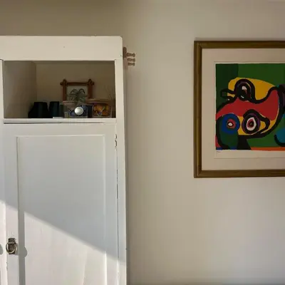 a door to a room with a painting on the wall at Cosy Garden Room Riverhouse in Ouderkerk aan de Amstel