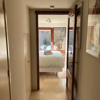 a bedroom with a bed and a view of a window at Cosy Garden Room Riverhouse in Ouderkerk aan de Amstel