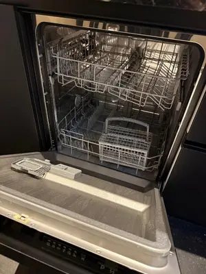 an open dishwasher with dishes in it at Stylish apartment near Amsterdam in Badhoevedorp