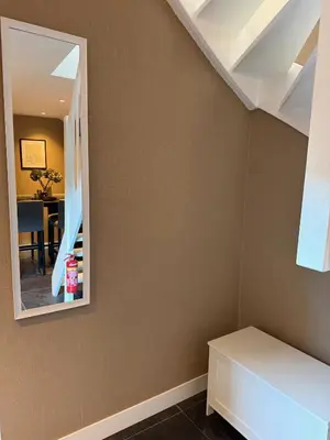 a room with a mirror and a table at Stylish apartment near Amsterdam in Badhoevedorp