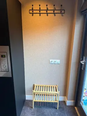 a wooden bench in a room with a wall at Stylish apartment near Amsterdam in Badhoevedorp