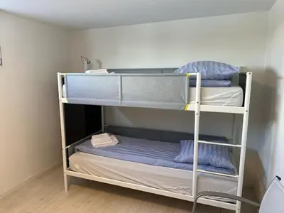 two bunk beds in a small room with at Houseboat the Otter incl free boat and supboards in Loosdrecht