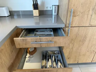 a drawer in a kitchen with utensils in it at Houseboat the Otter incl free boat and supboards in Loosdrecht