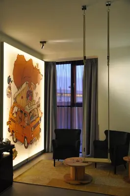 a living room with a large painting on the wall at Hotel Rauw aan de Kade in IJmuiden