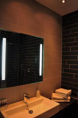 a bathroom with a sink and a mirror at Hotel Rauw aan de Kade in IJmuiden
