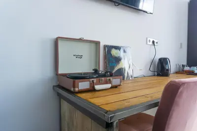 a suitcase sitting on top of a wooden table at Hotel Rauw aan de Kade in IJmuiden