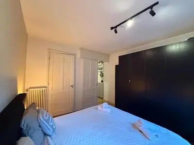 a bedroom with a bed with two slippers on it at Central Amsterdam Home Stay Near Museum Quarter & Vondelpark in Amsterdam
