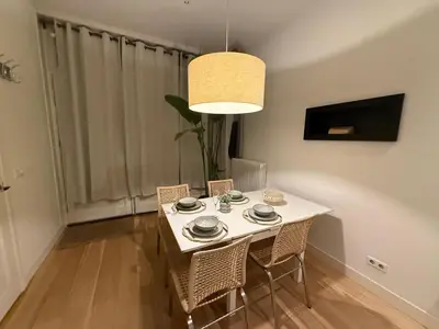 a dining room with a white table and chairs at Central Amsterdam Home Stay Near Museum Quarter & Vondelpark in Amsterdam