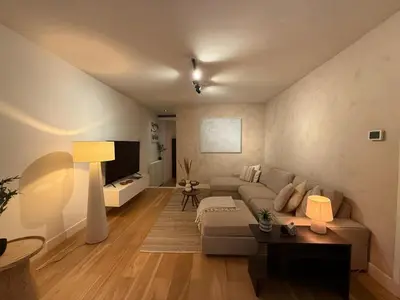 a living room with a couch and a tv at Central Amsterdam Home Stay Near Museum Quarter & Vondelpark in Amsterdam