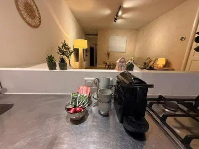 a kitchen counter with a coffee maker on a stove at Central Amsterdam Home Stay Near Museum Quarter & Vondelpark in Amsterdam