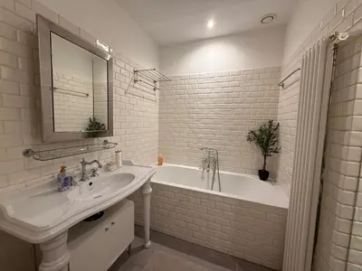 a bathroom with a tub and a sink and a bath tub at Central Amsterdam Home Stay Near Museum Quarter & Vondelpark in Amsterdam