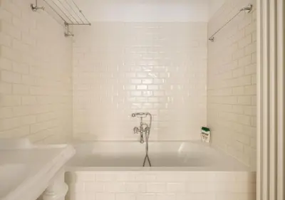 a white bathroom with a tub and a sink at Central Amsterdam Home Stay Near Museum Quarter & Vondelpark in Amsterdam