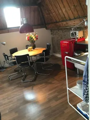 a kitchen with a table and chairs in a room at Penthouse Loft Central Harbour View, Free Parking in Ons Belang