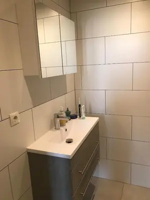 a bathroom with a sink and a mirror at Penthouse Loft Central Harbour View, Free Parking in Ons Belang