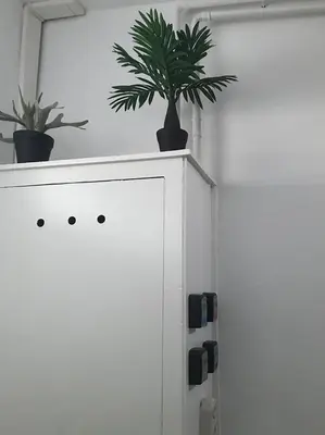 a white cabinet with two potted plants on top of it at Penthouse Loft Central Harbour View, Free Parking in Ons Belang