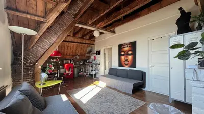 a living room with a couch and a table at Penthouse Loft Central Harbour View, Free Parking in Ons Belang