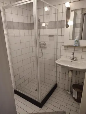 a bathroom with a shower and a sink at Gemütliches, komfortables Ferienhaus in Schoorl