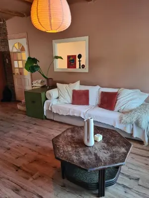 a living room with a white couch and a table at Spacious Eclectic Home Near Sea & Amsterdam in IJmuiden