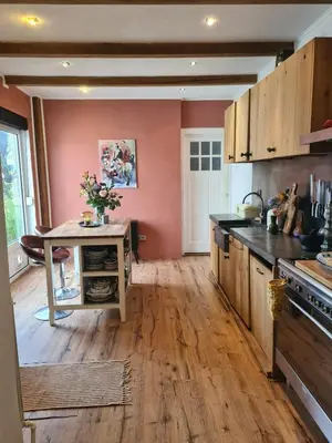 a kitchen with wooden floors and a table in it at Spacious Eclectic Home Near Sea & Amsterdam in IJmuiden