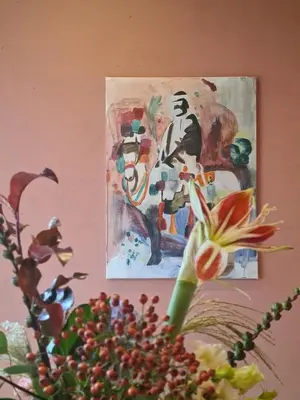 a painting hanging on a wall next to a flower at Spacious Eclectic Home Near Sea & Amsterdam in IJmuiden
