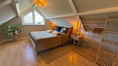 a bedroom with a bed in a attic at Tulipa - Keukenkof in Noordwijkerhout