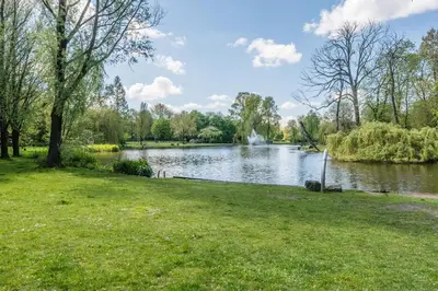 a park with a lake and a fountain at East-Side Living in Amsterdam