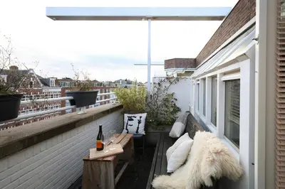 a balcony with a bench and a table on a building at East-Side Living in Amsterdam