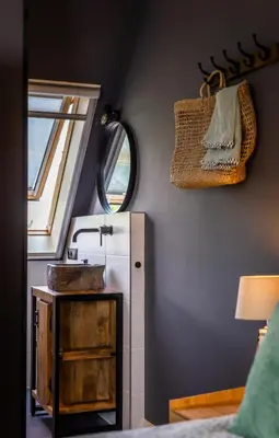 a small kitchen with a refrigerator and a window at Complete studio dichtbij Hoorn en Alkmaar in Zuidermeer