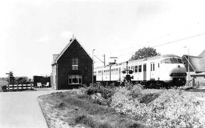 a black and white photo of a train next to a house at Complete studio dichtbij Hoorn en Alkmaar in Zuidermeer