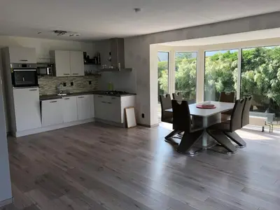 a kitchen and dining room with a table and chairs at Ferienhaus Aan de Gracht - IJsselmeer in Wervershoof