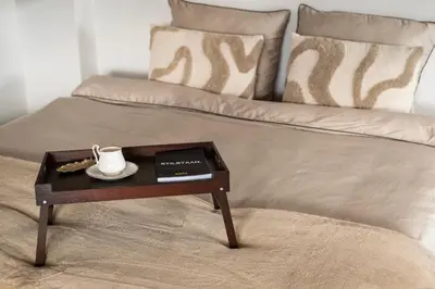 a coffee table with a tea pot on top of a bed at Villa COCO Aphrodite Apartment in Noordwijk