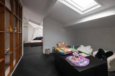 a living room with a table and a room with a bed at Villa COCO Aphrodite Apartment in Noordwijk
