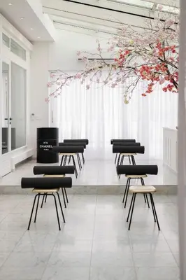 a room with chairs and flowers hanging from the ceiling at Villa COCO Aphrodite Apartment in Noordwijk