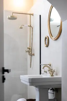 a bathroom with a sink and a mirror at Villa COCO Aphrodite Apartment in Noordwijk