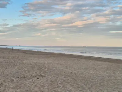 an empty beach with the ocean in the background at Ons Bijhuis in Wijk aan Zee