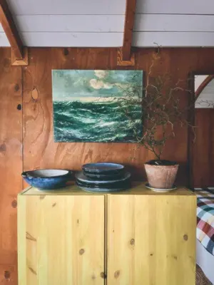 a wooden cabinet with plates on top of it at Tuiny House Noordwijk in Noordwijk