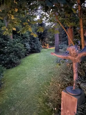 a statue of a woman on a stand in the grass at Klein Nieuwe Wegen in Ons Belang