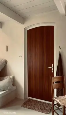 a wooden door in a room with a bed at Maison 1882 in Hauwert