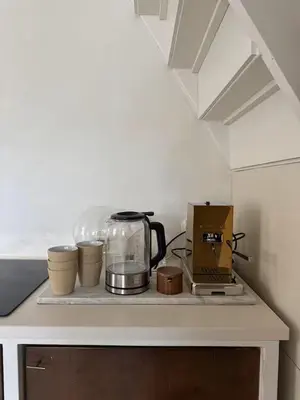 a kitchen counter with a coffee maker and pots and pans at Maison 1882 in Hauwert