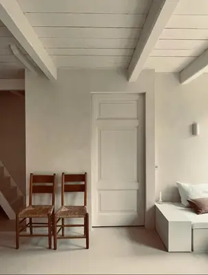 two chairs in a room with a door and a bed at Maison 1882 in Hauwert