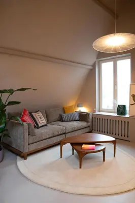 a living room with a couch and a coffee table at The Painters Loft sleeping among the art in Haarlem