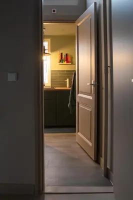 an open door leading to a kitchen with a sink at The Painters Loft sleeping among the art in Haarlem