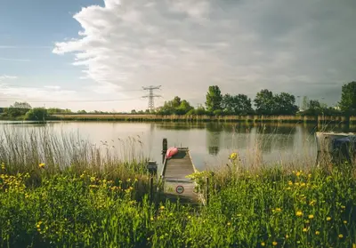 a small boat sitting in the middle of a lake at NEW! Cozy Studio 54 in Amsterdam