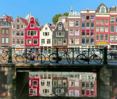 a group of bikes on a bridge in front of buildings at NEW! Cozy Studio 54 in Amsterdam