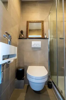 a bathroom with a toilet and a mirror at NEW! Cozy Studio 54 in Amsterdam