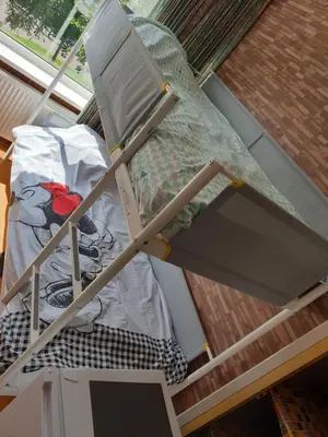 a bed sitting in a room next to a window at Short stay in Weesp